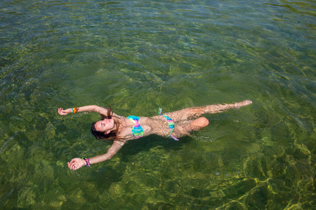 Girl swimming underwater in a swimming lakeの写真素材