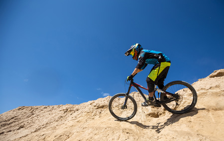 Young man on a mountain bike riding and relaxing in Charyn canyon,  Kazakhstan