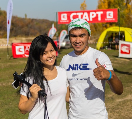 ALMATY,ALMATY DISTRICT, KAZAKHSTAN-OCTOBER 10, 2015: Beautiful couple participates in competitions in running, on the competition trail running Alatau Train Run 2016, in the national reserve Yunats Lakes among golden autumn  trees.のeditorial素材
