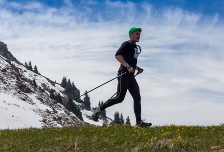 ALMATY, ALMATY DISTRIKT, KAZAKHSTAN - MAY 22, 2016: Open competition SKY RANNING 2016 held in Eliksay gorge. A man runs up to the mountain named Bukreeva participating in the competition.のeditorial素材