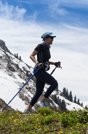 ALMATY, ALMATY DISTRIKT,KAZAKHSTAN - MAY 22, 2016: Open competition SKY RANNING 2016 held in Eliksay gorge. A girl runs up to the mountain named Bukreeva participating in the competition.のeditorial素材
