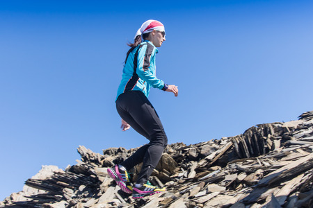 AKTRU,KURDAI,GORNII ALTAI / KAZAKHSTAN - JUNE 10: International Championship in the discipline skyrunning "Aktru 2016". Athletes from different countries compete in the championship in a very beautiful mountains of Altai. Beautiful girl runs up to the titのeditorial素材