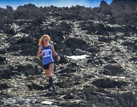 AKTRU,KURDAI,GORNII ALTAI / KAZAKHSTAN - JUNE 10: International Championship in the discipline skyrunning "Aktru 2016". Athletes from different countries compete in the championship in a very beautiful mountains of Altai. Beautiful girl runs up to the titのeditorial素材
