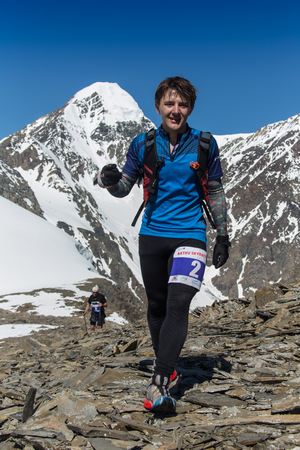 AKTRU,KURDAI,GORNII ALTAI / KAZAKHSTAN - JUNE 10: International Championship in the discipline skyrunning "Aktru 2016". Athletes from different countries compete in the championship in a very beautiful mountains of Altai. A strong man runs up to the titleのeditorial素材