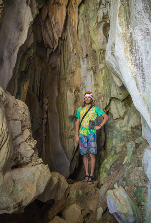 Sexy fit shirtless male model posing in beautiful cave setting with light streaming inの写真素材