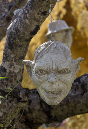 Scary Stone Heads - rock sculptures of giant heads carved into the sandstone cliff.