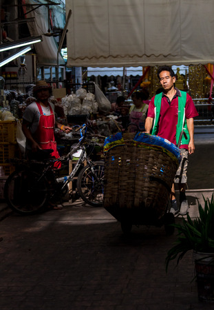 BANGKOK/THAILAND - 10 FEBRUARY 2016: Portrait of confident owner displaying fresh fish in store.のeditorial素材