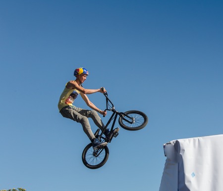 KAZAKHSTAN ALMATY - AUGUST 28, 2016: Urban extreme competition, where the city athletes compete in the disciplines: skateboard, roller skates, BMX. Bmx stunt performed at the top of a mini ramp on a skateparkのeditorial素材