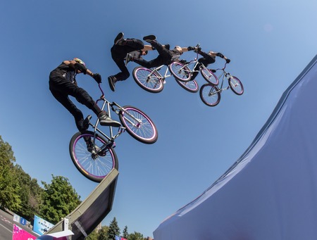 KAZAKHSTAN ALMATY - AUGUST 28, 2016: Urban extreme competition, where the city athletes compete in the disciplines: skateboard, roller skates, BMX. Bmx stunt performed at the top of a mini ramp on a skateparkのeditorial素材