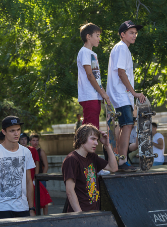 KAZAKHSTAN ALMATY - AUGUST 28, 2016: Urban extreme competition, where the city athletes compete in the disciplines: skateboard, roller skates, BMX. Bmx stunt performed at the top of a mini ramp on a skatepark.Winners team on the mountain top. Sport and acのeditorial素材