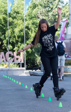 KAZAKHSTAN ALMATY - AUGUST 28, 2016: Urban extreme competition, where the city athletes compete in the disciplines: skateboard, roller skates, BMX. Bmx stunt performed at the top of a mini ramp on a skatepark.Get Away from the Office! - wide-angle shot, lのeditorial素材