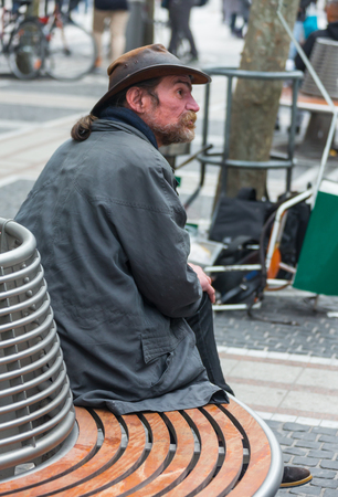 GERMANY, FRANKFURT: 12 DECEMBER 2016 - Serious handsome hipster man in winter clothes leaning on the concrete wall boxのeditorial素材