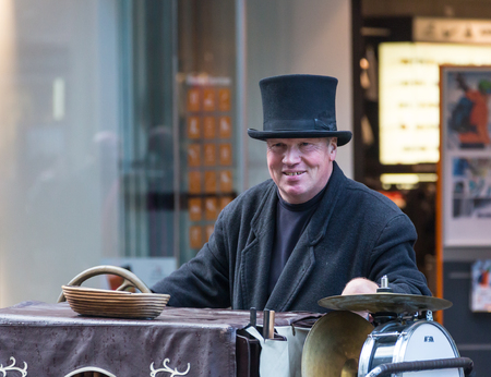 GERMANY, FRANKFURT: 12 DECEMBER 2016 - European street musicians who sitting on the pedestrian streets and playing music for charity.のeditorial素材