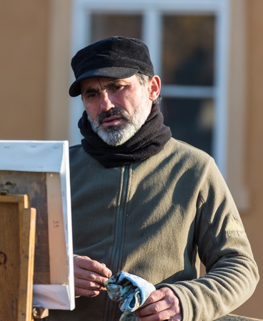 GERMANY, FRANKFURT: 12 DECEMBER 2016 - Public painter or street artist sketching a portrait outdoors.のeditorial素材