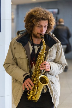 GERMANY, FRANKFURT: 12 DECEMBER 2016 - European street musicians who sitting on the pedestrian streets and playing music for charity.のeditorial素材