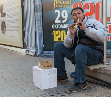 GERMANY, FRANKFURT: 12 DECEMBER 2016 - European street musicians who sitting on the pedestrian streets and playing music for charity.のeditorial素材