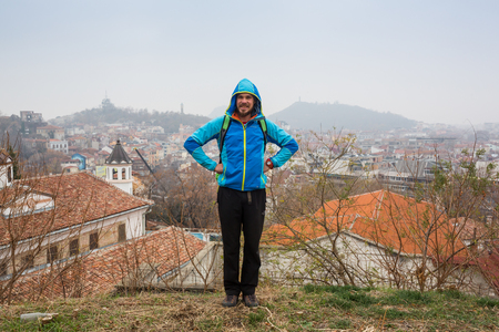 GERMANY, FRANKFURT: 12 DECEMBER 2016 - Serious handsome hipster man in winter clothes leaning on the concrete wall boxのeditorial素材