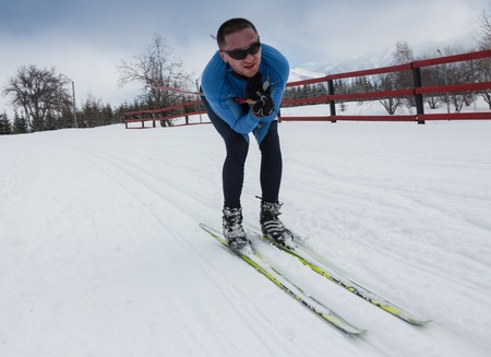 ALMATY, KAZAKHSTAN - FEBRUARY 18, 2017: amateur competitions in the discipline of cross-country skiing, under the name of ARBA Ski Fest. A man cross-country skiing on the trail in Almaty mountのeditorial素材