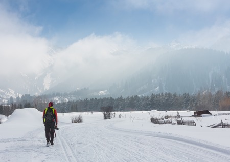 ALMATY, KAZAKHSTAN - FEBRUARY 18, 2017: amateur competitions in the discipline of cross-country skiing, under the name of ARBA Ski Fest. Nature photographer taking photos in the mountainsのeditorial素材