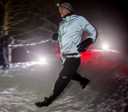 ALMATY, KAZAKHSTAN - 18 FEBRUARY 2017: Night competitions in the foothills of the city of Almaty, in the Trailrunning and Skyship discipline, which is called TunRun winter edition. Man running in the mountains at nightのeditorial素材