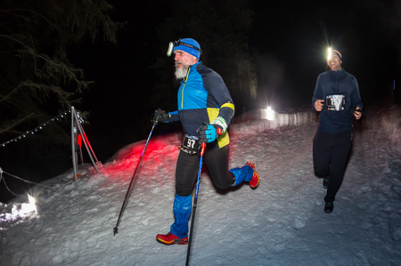ALMATY, KAZAKHSTAN - 18 FEBRUARY 2017: Night competitions in the foothills of the city of Almaty, in the Trailrunning and Skyship discipline, which is called TunRun winter edition. Man running in the mountains at nightのeditorial素材