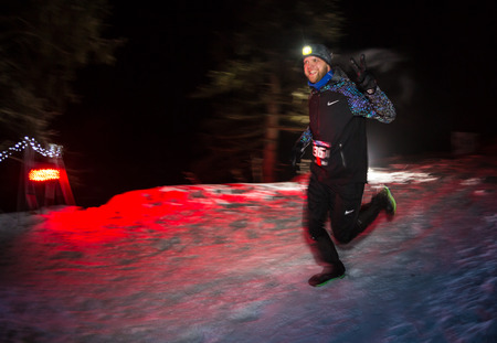 ALMATY, KAZAKHSTAN - 18 FEBRUARY 2017: Night competitions in the foothills of the city of Almaty, in the Trailrunning and Skyship discipline, which is called TunRun winter edition. Man running in the mountains at nightのeditorial素材
