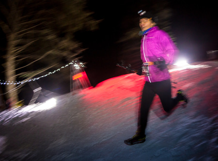 ALMATY, KAZAKHSTAN - 18 FEBRUARY 2017: Night competitions in the foothills of the city of Almaty, in the Trailrunning and Skyship discipline, which is called TunRun winter edition. Man running in the mountains at nightのeditorial素材