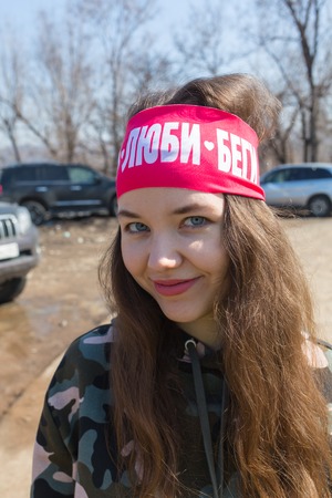 ALMATY, KAZAKHSTAN - APRIL 09, 2017: Amateur competitions - Mountain half-marathon, in the foothills of Almaty, on the Yunat lakes. Athletic Runner Training in a park for Marathon. Fitness Girl Running outdoors.のeditorial素材