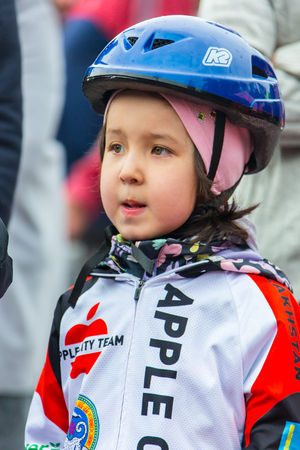 KAZAKHSTAN, ALMATY - JUNE 11, 2017: Childrens cycling competitions Tour de kids. Children aged 2 to 7 years compete in the stadium and receive prizes. Children at the solemn construction - waiting for the start of the competition.のeditorial素材