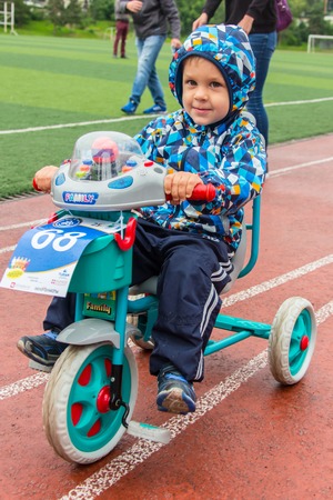 KAZAKHSTAN, ALMATY - JUNE 11, 2017: Childrens cycling competitions Tour de kids. Children aged 2 to 7 years compete in the stadium and receive prizes. A little boy rides a bike and competes to become a winner.のeditorial素材