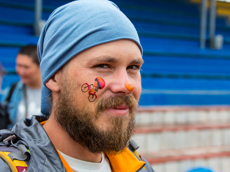 KAZAKHSTAN, ALMATY - JUNE 11, 2017: Childrens cycling competitions Tour de kids. Children aged 2 to 7 years compete in the stadium and receive prizes. A man in a cycle shop, reading the price label on a bikeのeditorial素材