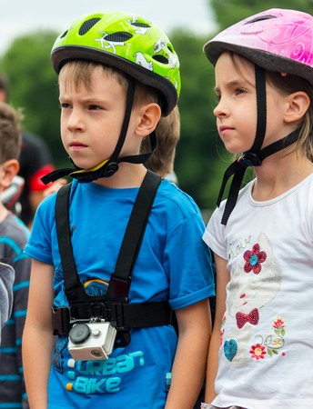 KAZAKHSTAN, ALMATY - JUNE 11, 2017: Childrens cycling competitions Tour de kids. Children aged 2 to 7 years compete in the stadium and receive prizes. Children at the solemn construction - waiting for the start of the competition.のeditorial素材