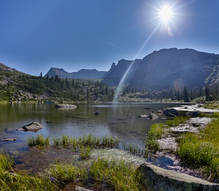 Fantastic sunny day is in mountain lake. Creative collage. Beauty world in the Ergaki national park, Russiaの写真素材