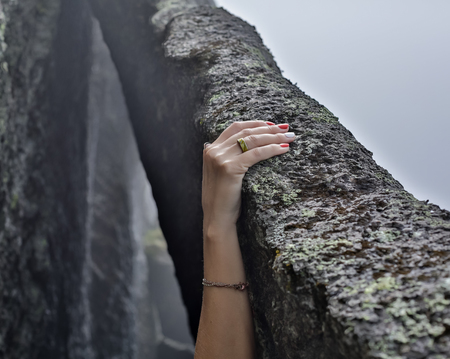 young woman rock climber hands climbing at seaside mountain cliff rock.の写真素材