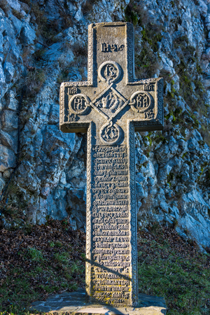 Bran, Romania - November 19, 2016: Medieval stone cross with religious symbols at the entrance to the Bran or Dracula Castle in Transylvania, Romaniaのeditorial素材