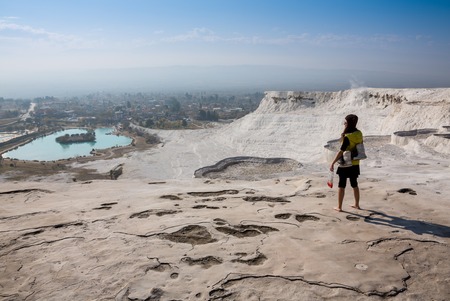 Woman walking on the terraces at Pamukkale. It cotton castle in Turkish and is natural siteの写真素材