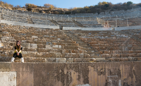 Woman in yellow dress in a sunglasses, Amphitheatre outdoor