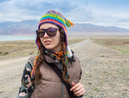 Young Woman standing alone outdoor with wild forest mountains on background Travel Lifestyle and survival concept rear viewの写真素材