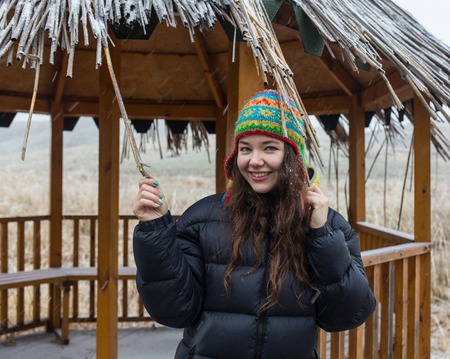 Outdoor close up portrait of young beautiful girl with long hair wearing hat, Christmas, winter holidays concept.の写真素材