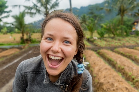 Woman smiling with perfect smile and white teeth in a park and looking at cameraの写真素材
