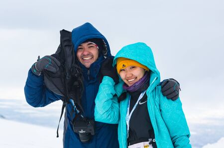 ALMATY KAZAKHSTAN - FEBRUARY 03 2019: portrait of an unknown couple in a snow blizzard during the...