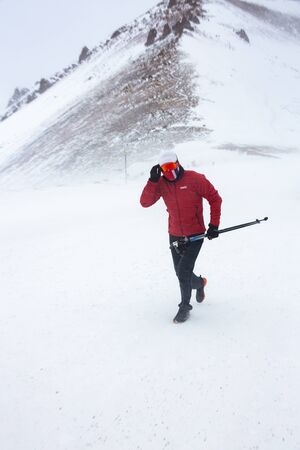 ALMATY KAZAKHSTAN - FEBRUARY 03 2019: An unidentified man runs through a snowstorm during a...