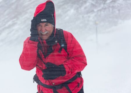 ALMATY KAZAKHSTAN - FEBRUARY 03 2019: portrait of an unknown man in a snow blizzard during the...
