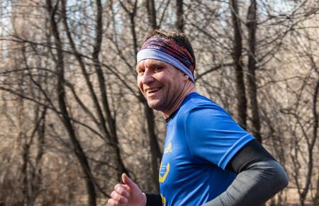 ALMATY, KAZAKHSTAN - March 16, 2019: portrait of a handsome mature unidentified man who runs through...