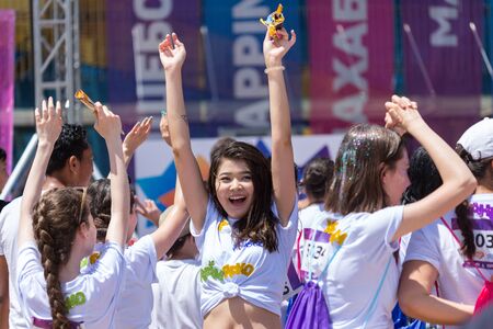 ALMATY, KAZAKHSTAN - JUNE 10, 2018: Unidentified people in front of the stage are dancing and are...