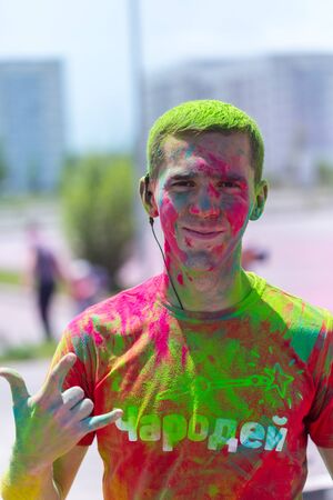 ALMATY, KAZAKHSTAN - JUNE 10, 2018: Unknown man sprinkled with bright paint smiles at Yarkokros party near the Almaty Arena stadium on June 10, Sunday in the city of Almaty.のeditorial素材