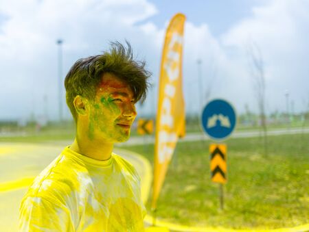ALMATY, KAZAKHSTAN - JUNE 10, 2018: Unknown man sprinkled with bright paint smiles at Yarkokros...
