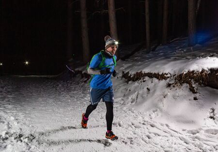 ALMATY KAZAKHSTAN: FEBRUARY 15, 2020: Unidentified people run at night in the mountains near the city of Almaty with flashlights during the night run of TunRun Limited on February 15, 2020のeditorial素材