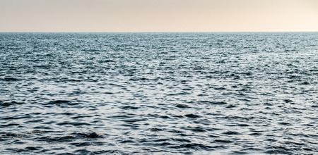 Calm and Blue ocean in High Seas with clear visible horizon and no landmass. Photograph taken in Arabian Sea in Indian territorial waters, while travelling for fishing to a distant island.の写真素材