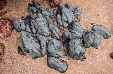 Deccan trap basaltic rock, dolerite dyke rock, found generally on goan beaches. A major part of the entire konkan region belt of the western ghats, and Indian Deccan plateau is made up of this rocks.の写真素材